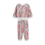The Eliza Two Piece Set by Mabel + Honey features a long-sleeve floral sweatshirt and matching joggers, both adorned with pink, white, and blue flowers and finished with light gray ribbed cuffs and waistband—making this charming set perfect for any occasion.