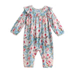 Introducing the Mabel + Honey Floral Flutter Romper—a long-sleeve romper featuring a gathered yoke and ruffle trim along the shoulders, designed with a blue background and pink and white watercolor floral print.