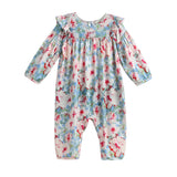 Introducing the Mabel + Honey Floral Flutter Romper—a long-sleeve romper featuring a gathered yoke and ruffle trim along the shoulders, designed with a blue background and pink and white watercolor floral print.