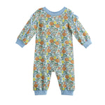 The Mabel + Honey Ivy Bloom Romper is a long-sleeve, cuffed romper for baby girls featuring a charming floral print with orange, yellow, and green daisies on a light blue background. It includes matching light blue cuffs and hem and is finished with sweet ribbon bow shoulder details.