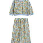 The Ivy Bloom Two Piece Set by Mabel + Honey features a long-sleeve floral sweatshirt paired with coordinating wide-leg pants. Adorned in light blue with a vibrant animal and nature print accented by playful daisies and finished with solid blue trim at the cuffs, neckline, and waistband, this charming set is perfect for cozy nights and sweet dreams.