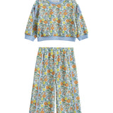 The Ivy Bloom Two Piece Set by Mabel + Honey features a long-sleeve floral sweatshirt paired with coordinating wide-leg pants. Adorned in light blue with a vibrant animal and nature print accented by playful daisies and finished with solid blue trim at the cuffs, neckline, and waistband, this charming set is perfect for cozy nights and sweet dreams.