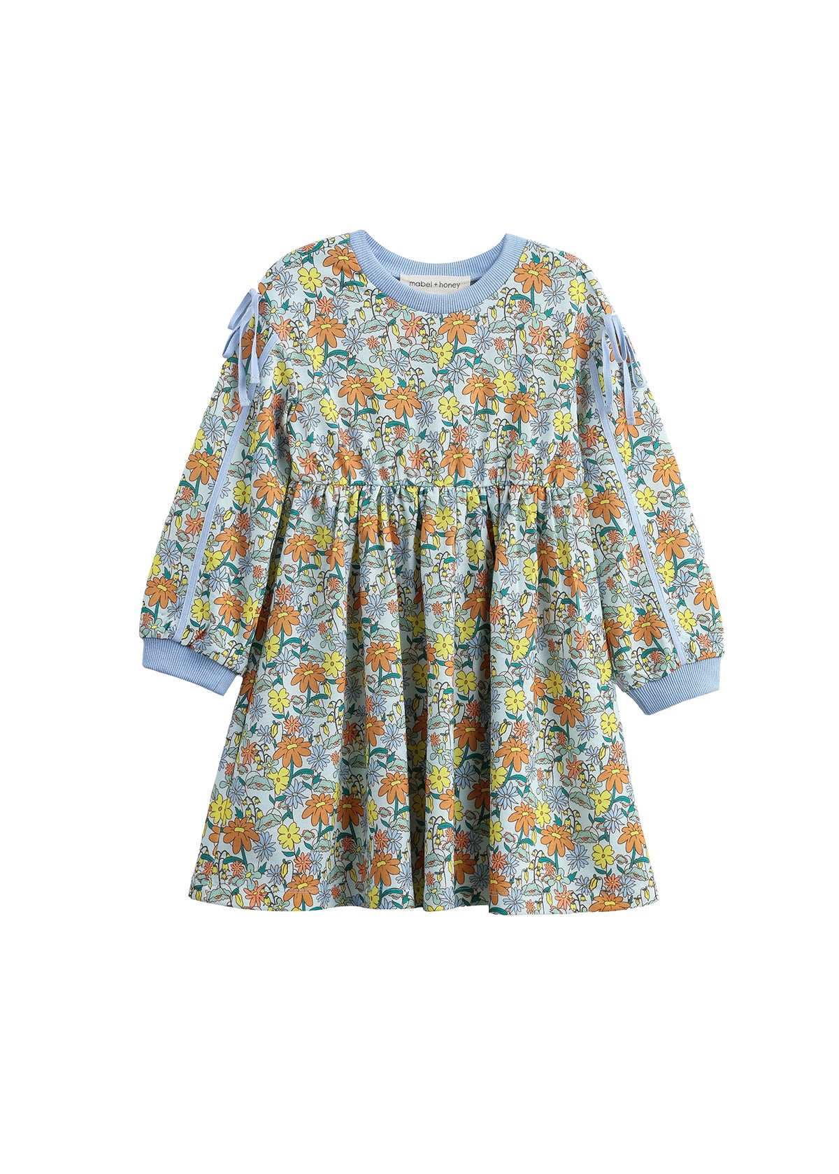 The Mabel + Honey Ivy Bloom Dress is a long-sleeve children’s dress featuring a colorful floral and leaf pattern, light blue cuffs and neckline, as well as charming ribbon bows on the sleeve slits and a gathered skirt.