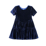 The Mabel + Honey Velvet Dreams Dress is a short-sleeved, knee-length party dress for kids in navy blue velvet, featuring a round neckline, a tiered skirt, and delicate crystal polka dot embellishments throughout the fabric.