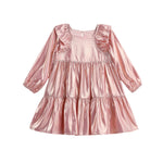The Isobella and Chloe Rosy Glow Long Sleeve Metallic Ruffle Trim Tiered Dress, shown against a white background, features shiny metallic pink fabric, ruffled shoulders, and a beautifully tiered skirt—making it the perfect choice for festive occasions.