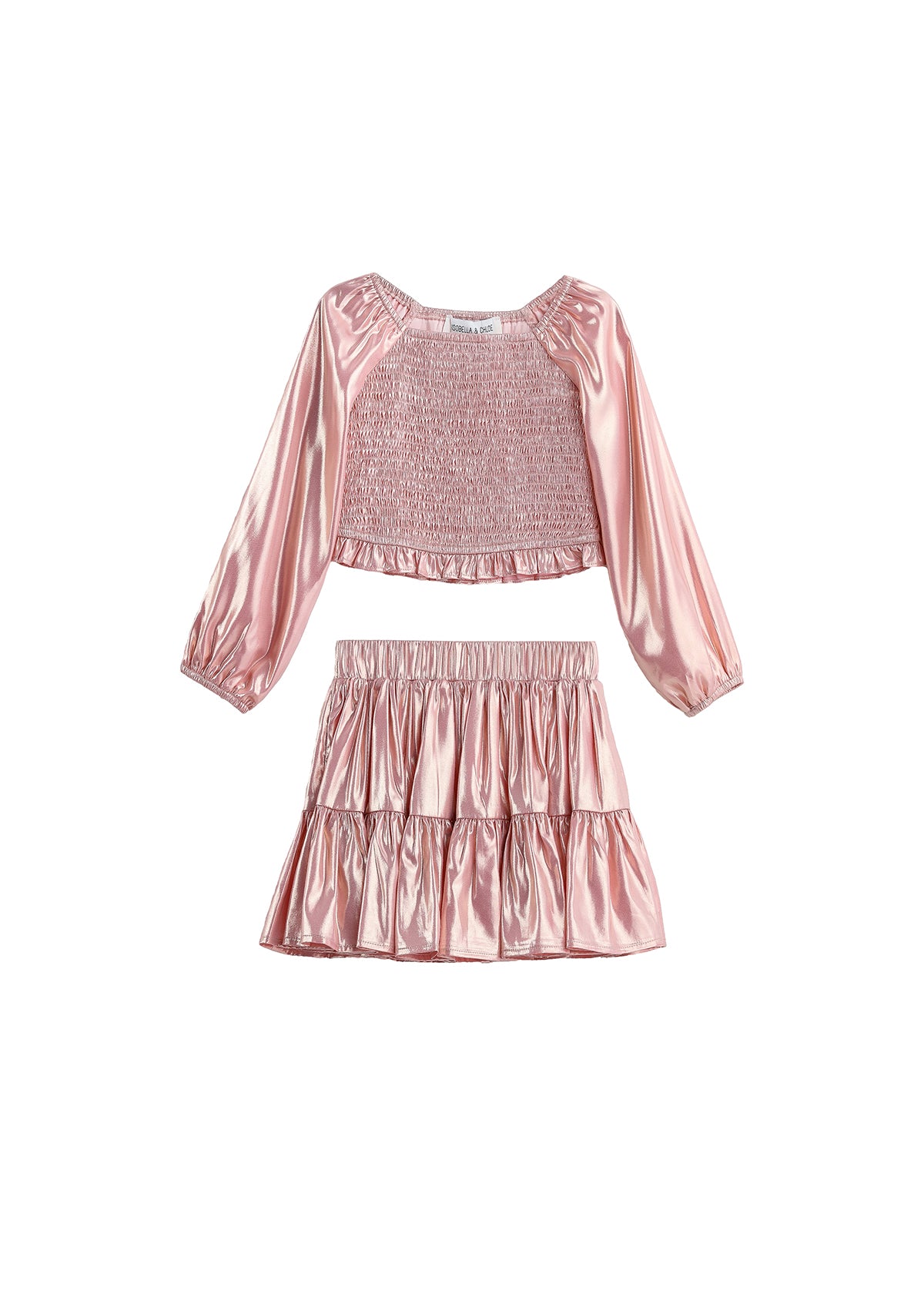 The Rosy Glow Two Piece Set by Mabel + Honey features a shiny pink metallic rose gold long-sleeve smocked crop top with gathered detailing, paired with a matching tiered skirt adorned with playful ruffles.