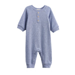 The Beckett and Bear Daniel Long Sleeve Solid Ribbed Button Placket Straight Leg Romper is a heathered blue, ribbed knit baby romper featuring long sleeves, three chest buttons, ribbed cuffs, and convenient snap closures at the legs for easy diaper changes—displayed on a white background.