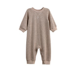 The Beckett and Bear Levi Long Sleeve Ribbed Knit Straight Leg Romper in beige features ribbed knit cuffs and practical snap closures at the legs, shown against a white background.