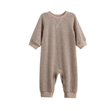 The Beckett and Bear Levi Long Sleeve Ribbed Knit Straight Leg Romper in beige features ribbed knit cuffs and practical snap closures at the legs, shown against a white background.