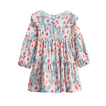 The Mabel + Honey Floral Flutter Dress is a children’s long-sleeve dress featuring a blue base with a pink, red, and white floral print, ruffle shoulders, bishop sleeves, a round neckline, and an enchanting tiered skirt.