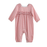 The Rosie Posie Long Sleeve Gingham Ruffle Waist Bubble Romper by Mabel and Honey features a charming red and white coral gingham pattern, ruffle detailing across the chest, and convenient snap buttons along the legs. Crafted from lightweight cotton with a gentle bubble silhouette, this romper is as comfortable as it is adorable.