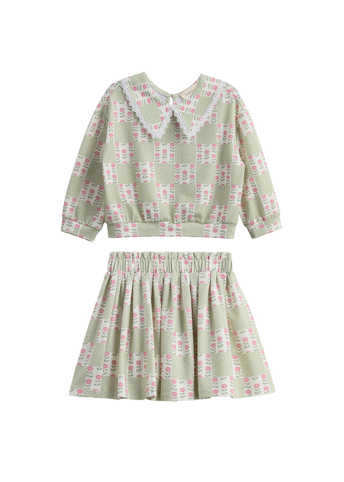 Introducing the Olive Two Piece Set by Mabel + Honey—a charming children’s outfit featuring a long-sleeve top with an elegant floral lace collar and a coordinating skirt. Both pieces showcase a stylish sage green hue adorned with delicate floral patterns, offering an adorable and refined option for everyday wear that stands out from typical checkered or novelty-print sets.
