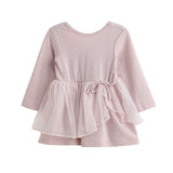 The Emma Dress Long Sleeve Solid Tiered Tulle Skirt Dress by Mabel + Honey features a light pink hue, a textured bodice, and a layered tulle skirt that’s perfect for twirling. Designed with a round neckline and a tied sash at the waist for added detail, this dress coordinates beautifully as part of matching sibling outfits.