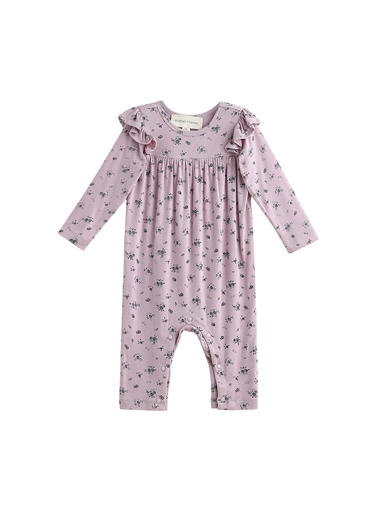 The Mabel + Honey Victoria Romper Long Sleeve Floral Print Ruffle Shoulder Straight Leg Romper features delicate ruffle details on the shoulders and a charming small floral print throughout. Perfect for sibling matching outfits!.