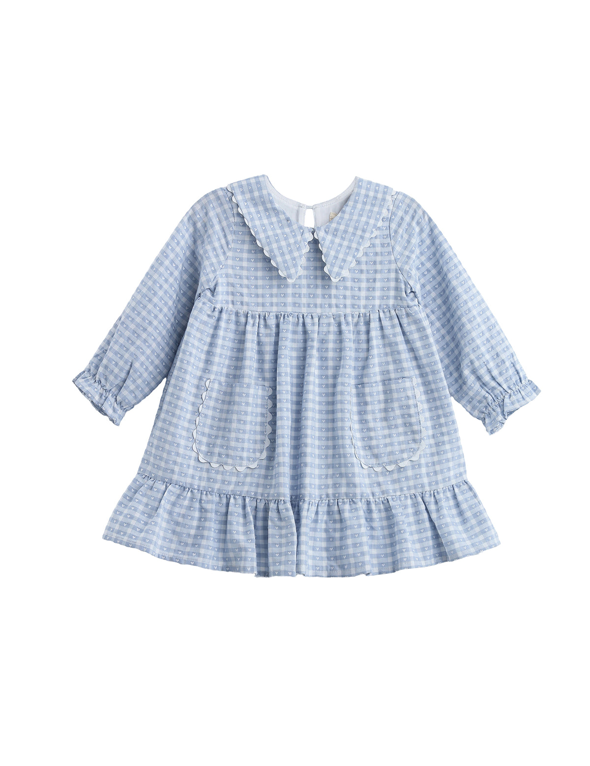 The Mabel + Honey Ella Rae Dress is a long sleeve plaid empire waist dress for children, featuring a light blue and white gingham pattern with a ruffled hem, two front pockets, and an adorable Peter Pan collar. With soft, vintage-inspired details like gathered cuffs, this dress is perfect for sibling matching outfits.