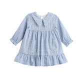 The Mabel + Honey Ella Rae Dress is a long sleeve plaid empire waist dress for children, featuring a light blue and white gingham pattern with a ruffled hem, two front pockets, and an adorable Peter Pan collar. With soft, vintage-inspired details like gathered cuffs, this dress is perfect for sibling matching outfits.