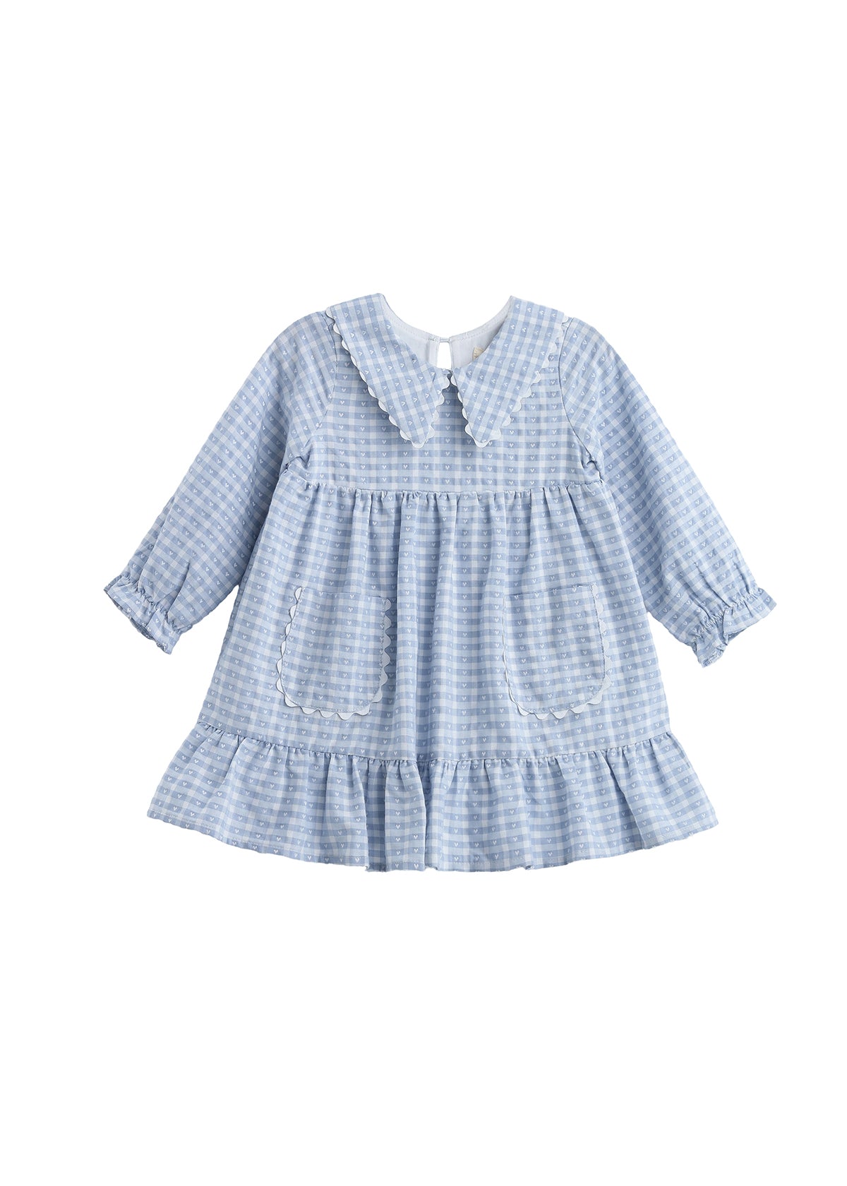 The Mabel + Honey Ella Rae Dress is a long sleeve plaid empire waist dress for children, featuring a light blue and white gingham pattern with a ruffled hem, two front pockets, and an adorable Peter Pan collar. With soft, vintage-inspired details like gathered cuffs, this dress is perfect for sibling matching outfits.