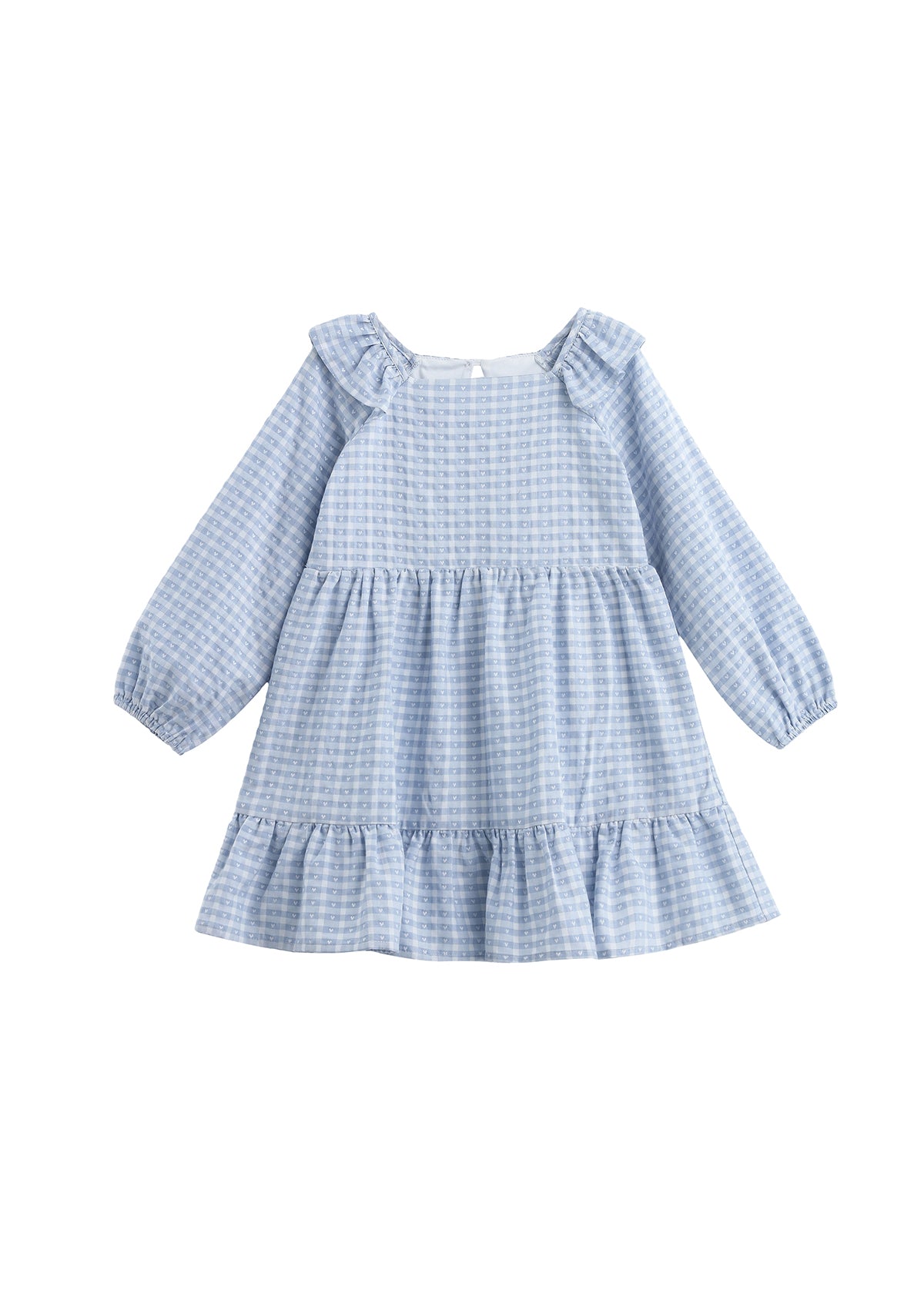 The Ella Rae Dress by Mabel + Honey is a long-sleeve girls’ cotton dress featuring light blue plaid, ruffled shoulders, a charming heart accent, and a tiered, gathered skirt.