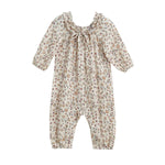 The Autumn Breeze Romper by Mabel + Honey is a long sleeve floral romper featuring a ruffle collar, gathered cuffs, and a cream background with small muted floral prints.