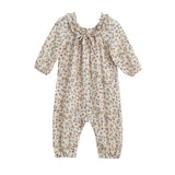 The Autumn Breeze Romper by Mabel + Honey is a long sleeve floral romper featuring a ruffle collar, gathered cuffs, and a cream background with small muted floral prints.
