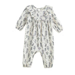 The Gracie Long Sleeve Floral Ruffle Collar Bubble Romper by Mabel and Honey is a cream-colored baby romper featuring long sleeves, a ruffled collar, and a charming wildflower floral print. Designed for comfort, it includes elastic cuffs at the ankles and wrists and is made from a soft stretch jersey knit fabric to ensure an ideal fit for your little one.