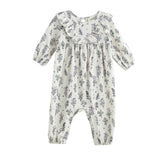 The Gracie Long Sleeve Floral Ruffle Collar Bubble Romper by Mabel and Honey is a cream-colored baby romper featuring long sleeves, a ruffled collar, and a charming wildflower floral print. Designed for comfort, it includes elastic cuffs at the ankles and wrists and is made from a soft stretch jersey knit fabric to ensure an ideal fit for your little one.