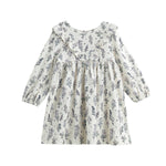 The Mabel + Honey Gracie Dress Long Sleeve Floral Ruffle Trim Empire Waist Dress is a white everyday dress for girls, adorned with a charming blue floral print and delicate ruffle details along the chest and shoulders, thoughtfully designed for young children.
