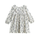 The Mabel + Honey Gracie Dress Long Sleeve Floral Ruffle Trim Empire Waist Dress is a white everyday dress for girls, adorned with a charming blue floral print and delicate ruffle details along the chest and shoulders, thoughtfully designed for young children.