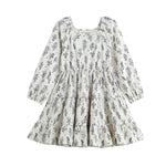 The Gracie Dress Long Sleeve Floral Print Tiered A Line Dress by Mabel + Honey features a white, long-sleeve design with blue wildflower prints, a tiered skirt, square neckline, and a flowy A-line silhouette for girls.