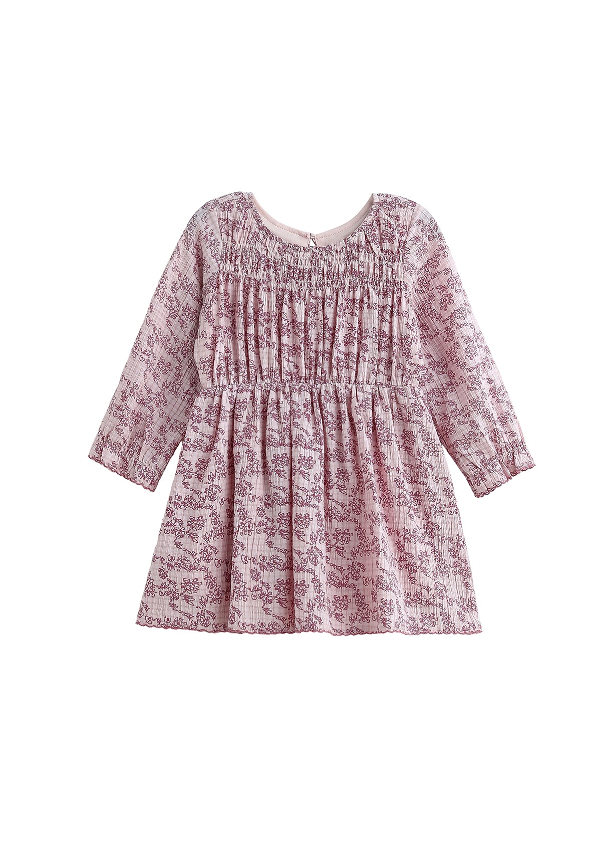 The Mabel and Honey Loretta Long Sleeve Floral Smocked Yoke A Line Dress is a pink, long-sleeved child’s dress with a gathered bodice and flared skirt, crafted from soft cotton gauze for comfort and shown on a white background.