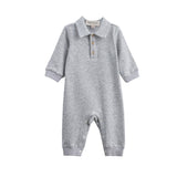 The Beckett and Bear Jacob Long Sleeve Solid Collared Ribbed Trim Romper is crafted from a soft cotton-blend knit in heathered gray, featuring long sleeves, a charming collar, and a button-up chest. Convenient snap closures line the legs for easy changes. Shown on a white background.