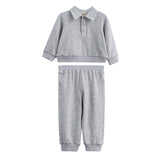 The Jacob Two Piece Set from Mabel + Honey features a long sleeve solid polo top with buttons and matching heather grey joggers, both designed for comfort and casual style. This soft, light gray set includes an elastic waistband and cuffs for an easy fit, making it perfect for everyday wear.