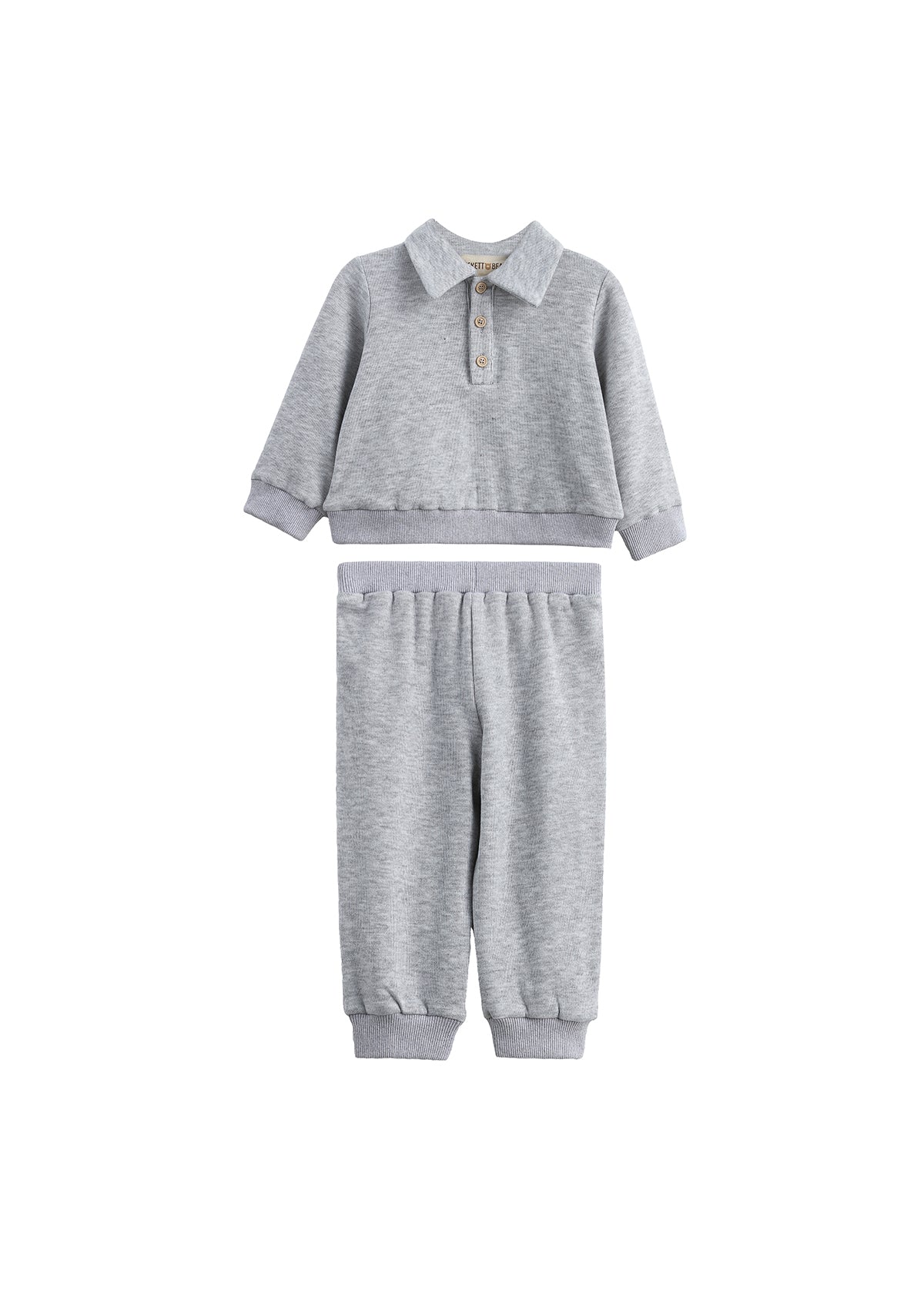 The Jacob Two Piece Set from Mabel + Honey features a long sleeve solid polo top with buttons and matching heather grey joggers, both designed for comfort and casual style. This soft, light gray set includes an elastic waistband and cuffs for an easy fit, making it perfect for everyday wear.