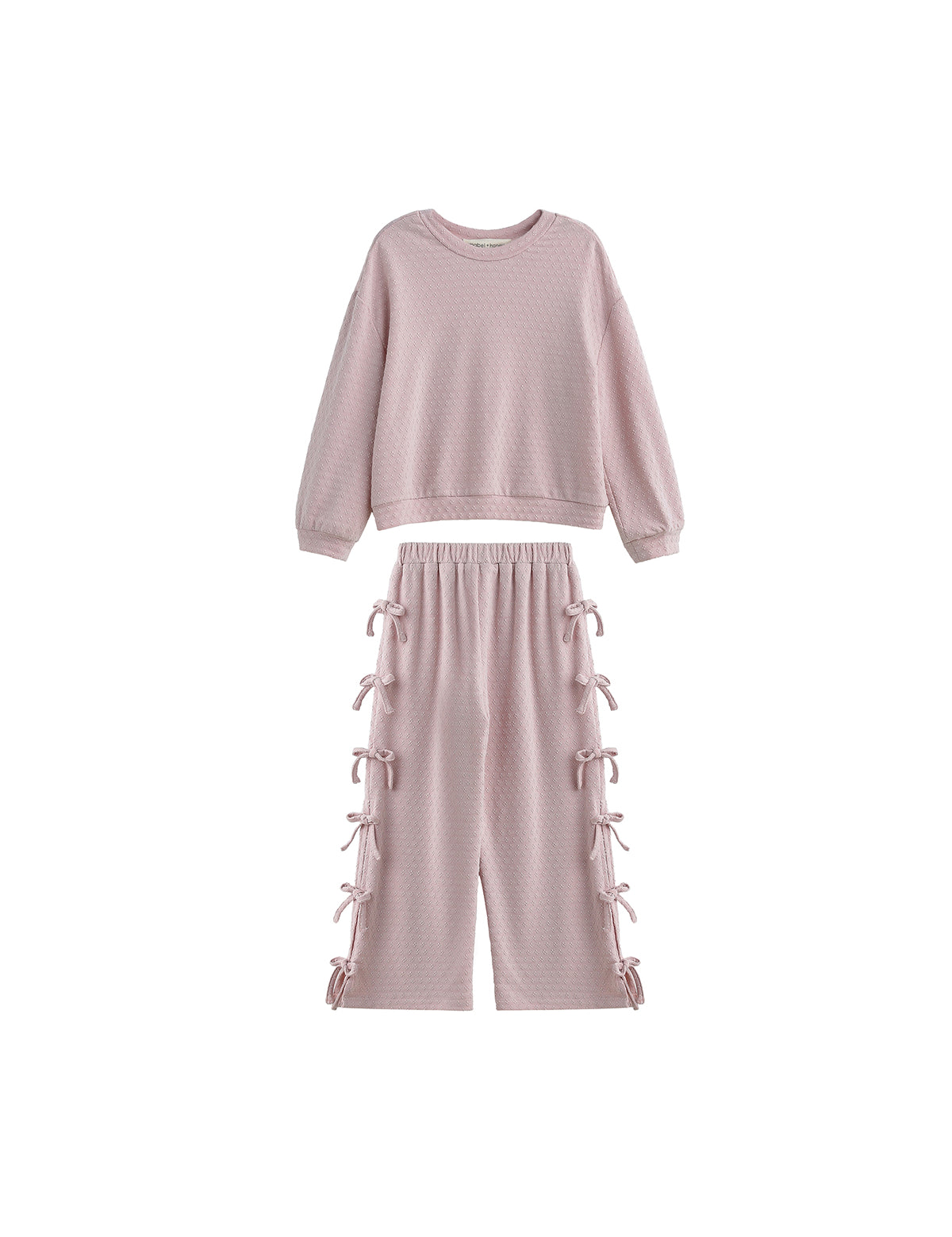 The Emma Two Piece Set Long Sleeve Textured Top And Wide Leg Pant Two Piece Set by Mabel + Honey showcases a light pink, textured knit ensemble with a long-sleeve top and matching wide-leg pants featuring bow-tied details and an elastic waistband, all presented against a white background.