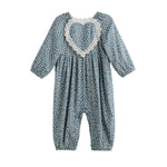 The Mabel + Honey Dolly Romper Long Sleeve Floral Lace Heart Bubble Romper features a charming blue design with white polka dots, long sleeves, and a large heart-shaped lace detail on the chest. With gathered fabric at the neck and ankles, this adorable romper is perfect for your baby girl’s fall wardrobe.