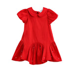 The Mabel + Honey Crimson Glow Dress Puff Sleeve Solid Dropwaist Pearl Embellished Dress is a vibrant holiday red dress for girls, designed with short puff sleeves, a charming Peter Pan collar, and a flared ruffled hem. Pearl embellishments accent the skirt for added elegance. This ruffled girls’ dress is displayed against a plain white background.