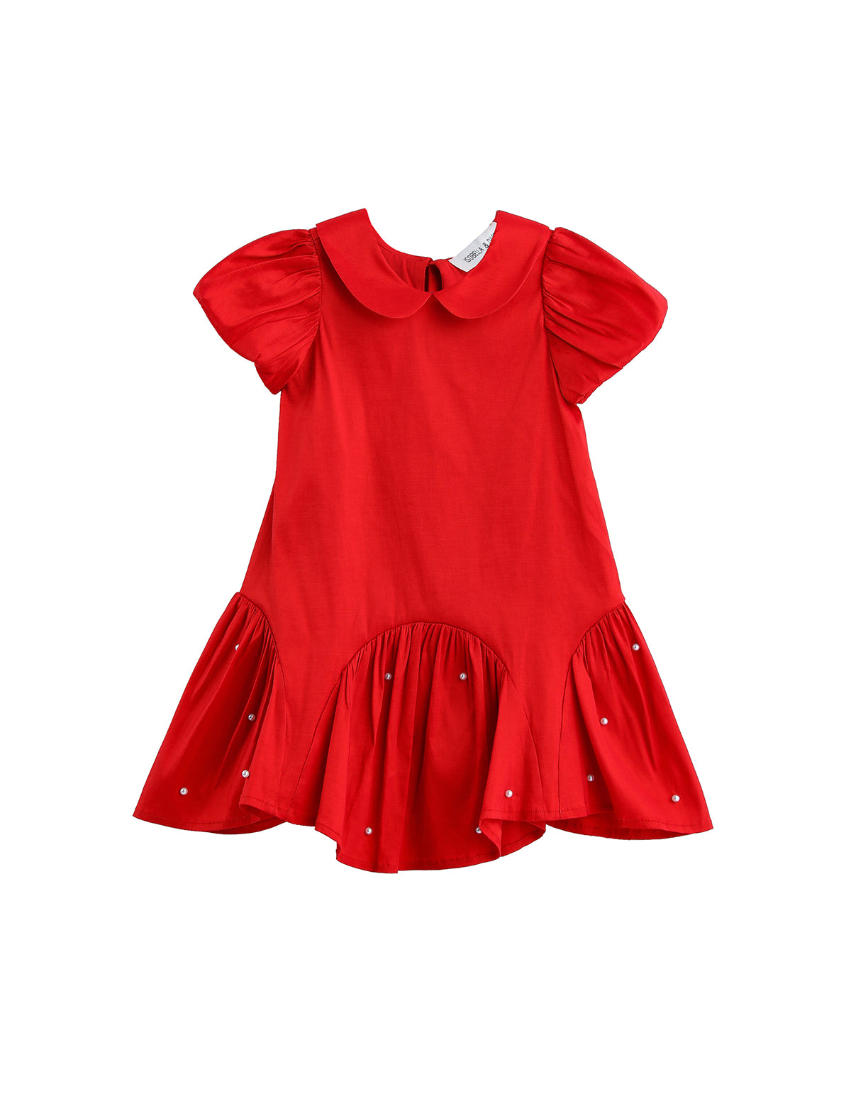 The Mabel + Honey Crimson Glow Dress Puff Sleeve Solid Dropwaist Pearl Embellished Dress is a vibrant holiday red dress for girls, designed with short puff sleeves, a charming Peter Pan collar, and a flared ruffled hem. Pearl embellishments accent the skirt for added elegance. This ruffled girls’ dress is displayed against a plain white background.