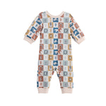 The Mabel + Honey Westin Romper Long Sleeve Print Straight Leg Romper showcases a vibrant checkerboard pattern adorned with playful cacti, suns, cows, horses, and boots. Its cozy long sleeves complement solid light beige accents at the cuffs, neckline, and ankles for added charm. This adorable romper is perfect for bringing a touch of Western flair to your little one’s wardrobe!.