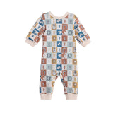 The Mabel + Honey Westin Romper Long Sleeve Print Straight Leg Romper showcases a vibrant checkerboard pattern adorned with playful cacti, suns, cows, horses, and boots. Its cozy long sleeves complement solid light beige accents at the cuffs, neckline, and ankles for added charm. This adorable romper is perfect for bringing a touch of Western flair to your little one’s wardrobe!.