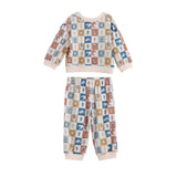 Introducing the Beckett and Bear Westin Long Sleeve Western Print Sweatshirt and Jogger Set: a two-piece children’s loungewear set crafted from soft cotton knit for ultimate comfort. This cozy ensemble features a pastel-colored checkerboard print adorned with charming animal and nature icons on each square, paired with light pink cuffs and collar for a sweet, playful touch.