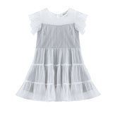 The Mabel + Honey Shimmer Shine Dress Flutter Sleeve Polka Dot Tiered Party Dress features white and light gray hues, short sleeves with sheer, dotted fabric, and ruffled layers on the skirt—an ideal holiday dress for special occasions. Displayed on a white background.