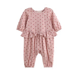 Dress your little one in the Mabel + Honey Love me Lots Romper Long Sleeve Heart Print Ruffle Waist Romper—featuring a playful pink design with red heart prints, ruffle details at the waist, and elastic cuffs at the wrists and ankles. This adorable piece is perfect for girls as a Valentine’s Day outfit!.