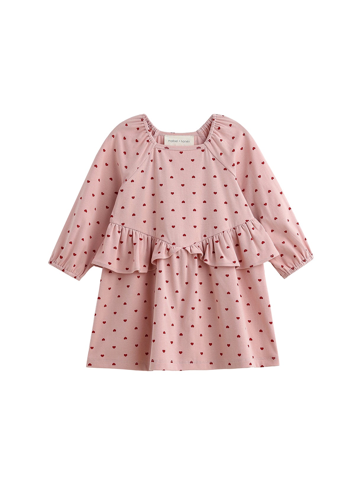The Love me Lots Dress Long Sleeve Heart Print Ruffle Waist Dress by Mabel + Honey features a charming pink design with a ruffled waist and adorable small red heart pattern, making it the perfect choice for your little one or as part of matching sibling outfits for girls’ Valentine’s dress celebrations. Displayed on a white background, this sweet dress adds extra love to any occasion.