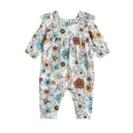 Dress your baby in the Autumn Blooms Romper by Mabel + Honey—a long-sleeve, straight leg romper featuring a ruffle neck and an all-over print of orange, blue, and beige florals on a white background—perfect for autumn or as a charming matching sibling outfit.
