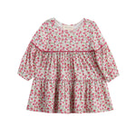 The Mabel + Honey Caroline Dress is a long-sleeve, tiered bishop sleeve dress featuring a ditsy floral print in pink and green. Designed with a round neckline, gathered waist, and ruffled tiers, this girls’ fall dress offers a loose, flowy fit that’s perfect for any occasion.