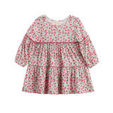 The Mabel + Honey Caroline Dress is a long-sleeve, tiered bishop sleeve dress featuring a ditsy floral print in pink and green. Designed with a round neckline, gathered waist, and ruffled tiers, this girls’ fall dress offers a loose, flowy fit that’s perfect for any occasion.