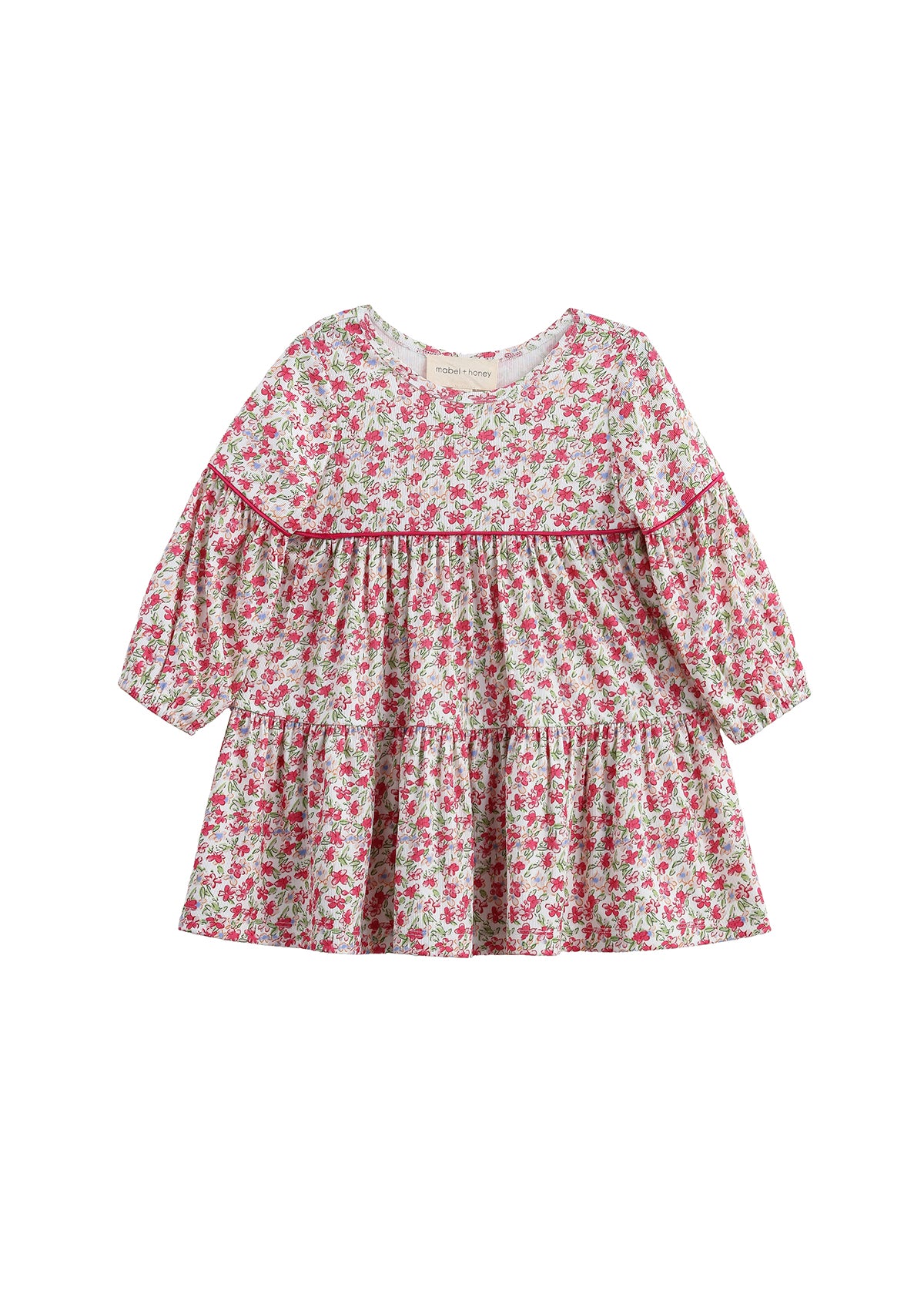 The Mabel + Honey Caroline Dress is a long-sleeve, tiered bishop sleeve dress featuring a ditsy floral print in pink and green. Designed with a round neckline, gathered waist, and ruffled tiers, this girls’ fall dress offers a loose, flowy fit that’s perfect for any occasion.