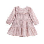 The Mabel + Honey Dusty Rose Dress Long Sleeve Floral Sequin Embroidered Tiered Dress features a light pink hue with ruffles, floral sequin embroidery, a tiered skirt, and a round neckline. This party dress has a delicate and feminine design, perfect for young children.