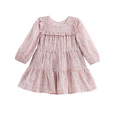 The Mabel + Honey Dusty Rose Dress Long Sleeve Floral Sequin Embroidered Tiered Dress features a light pink hue with ruffles, floral sequin embroidery, a tiered skirt, and a round neckline. This party dress has a delicate and feminine design, perfect for young children.