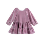The Sugarplum Sparkle Dress by Mabel + Honey is a mauve, long-sleeve girls’ holiday dress crafted from soft velvet. It features an A-line silhouette, tiered ruffle skirt, and gently gathered sleeves for a festive look.